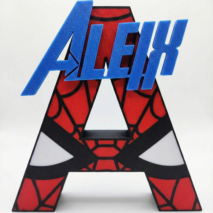Inicial mayúscula 'A' personalizada con diseño de Spiderman en rojo y negro, con el nombre 'ALEIX' superpuesto en azul en relieve.