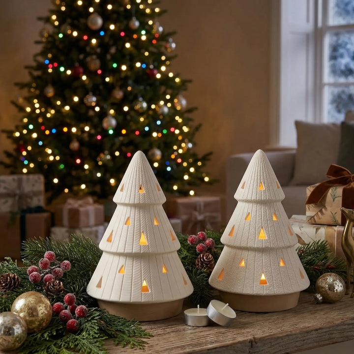 Paar kerstboomvormige kaarsenhouders met driehoekige uitsnijdingen en warm licht in hedendaags interieur.