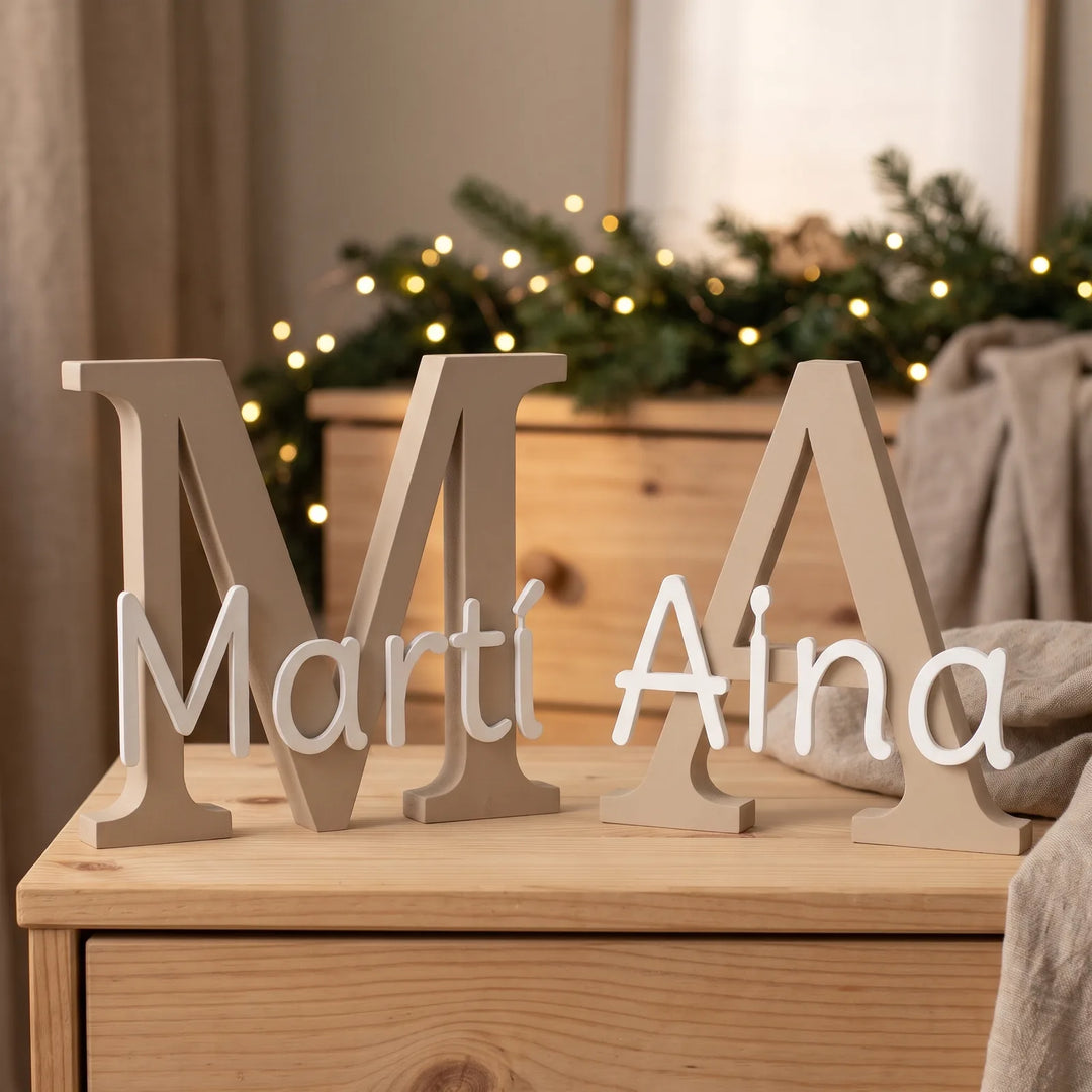 Dos letras con nombre sobre una cómoda en Navidad